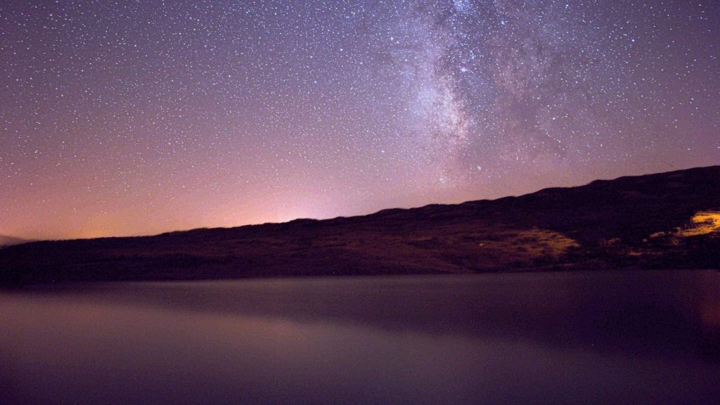Two Scottish destinations make it into Europe’s top stargazing spots The Milky Way over a still loch and hills under a dark sky